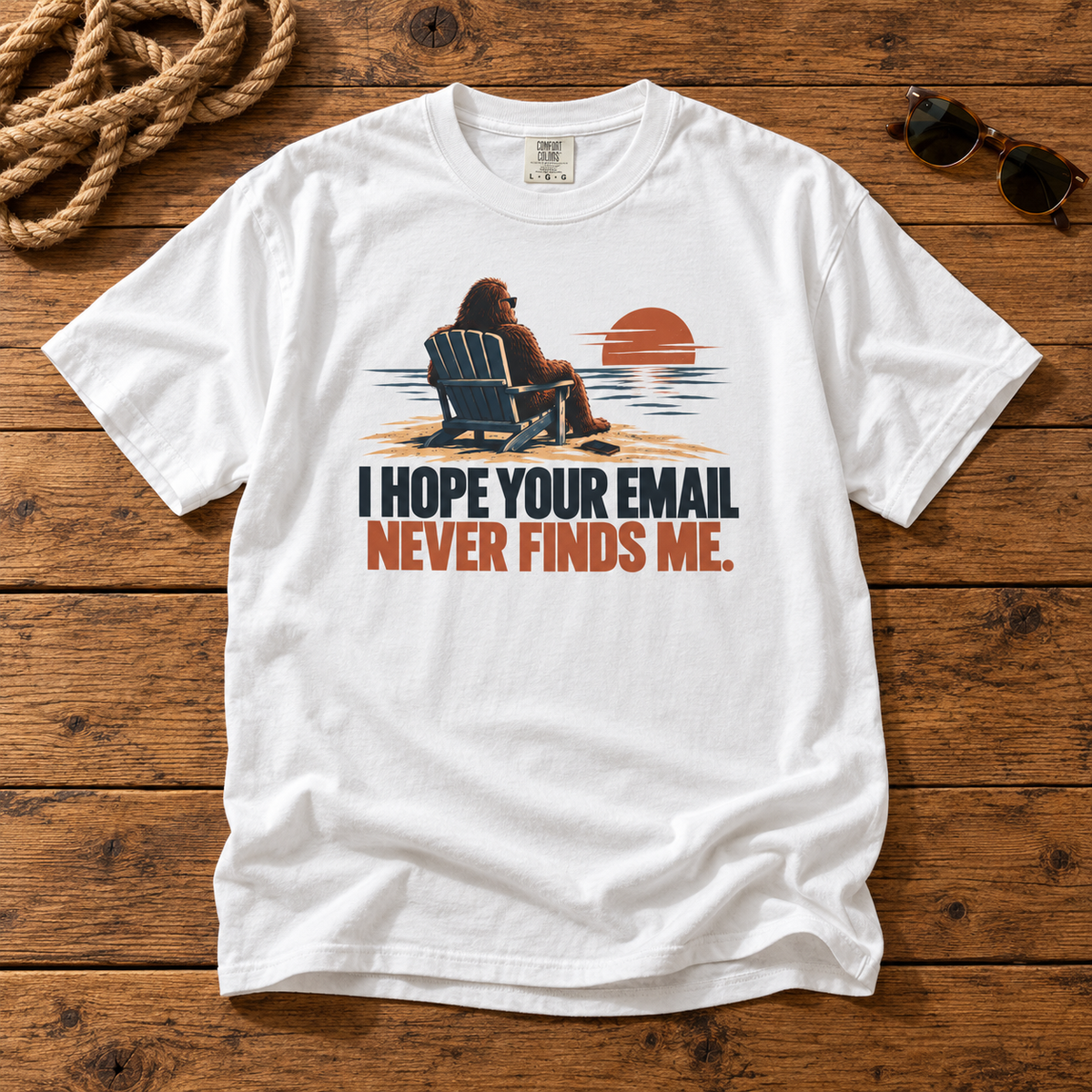 I Hope Your Email Never Finds Me Comfort Colors 1717 tee in White — front Bigfoot, chair and sunset artwork on rustic wood