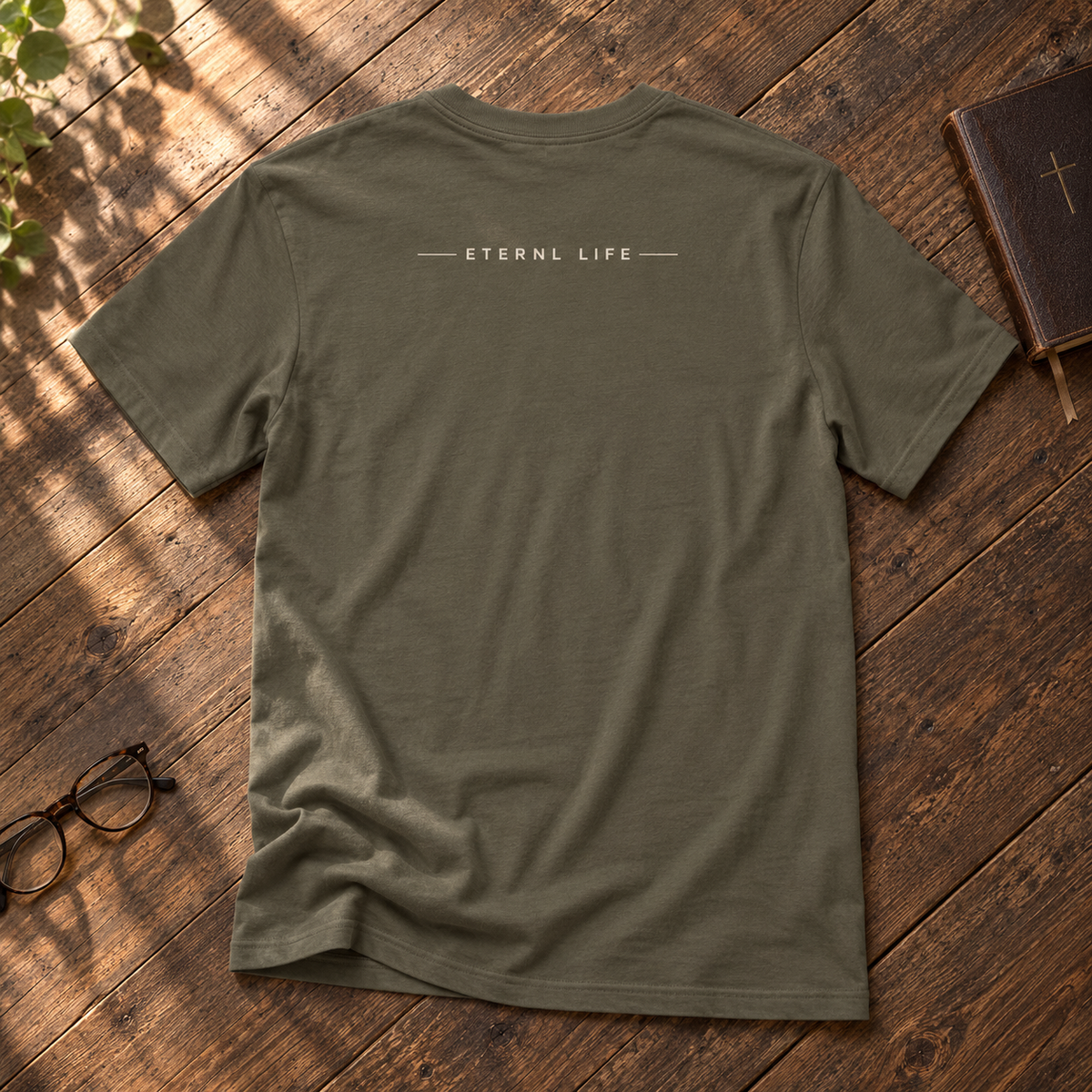 REDEEMED. army tee back with ETERNL LIFE wordmark on rustic wood