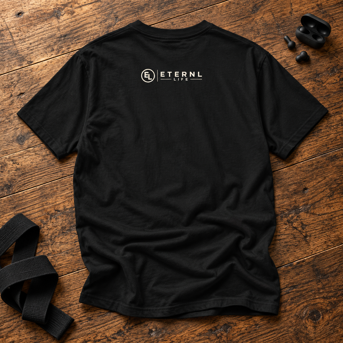 Strong Body. Steady Soul. Black tee back on rustic wood